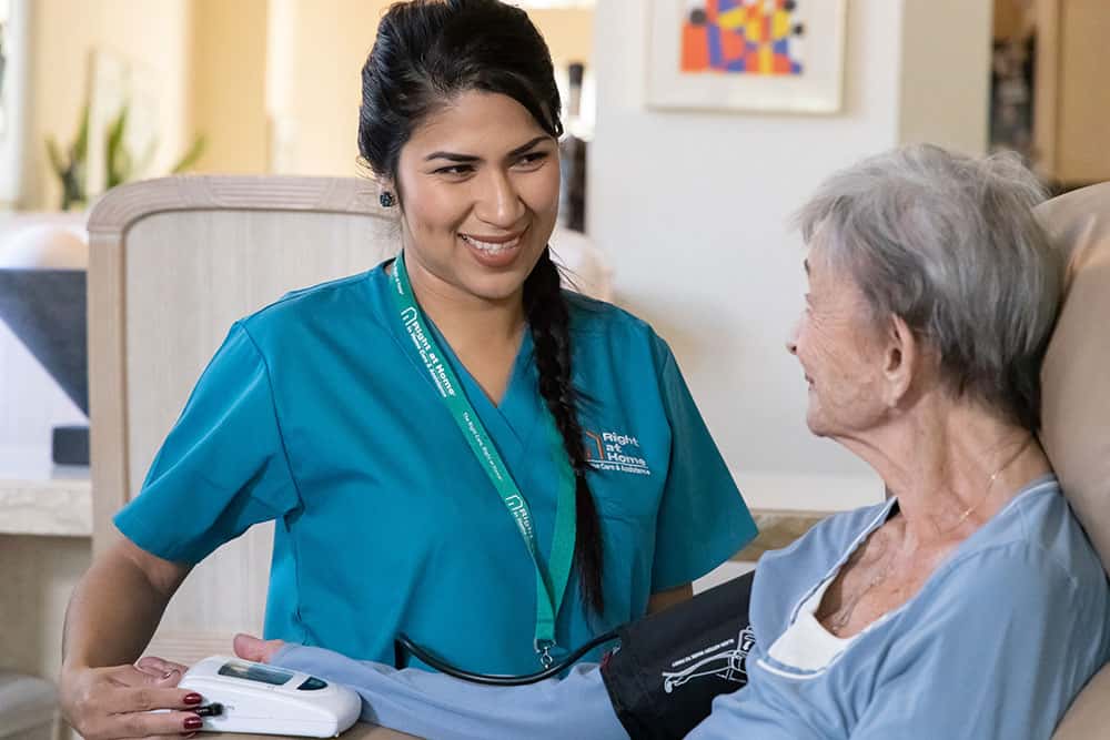 Caregiver taking blood pressure